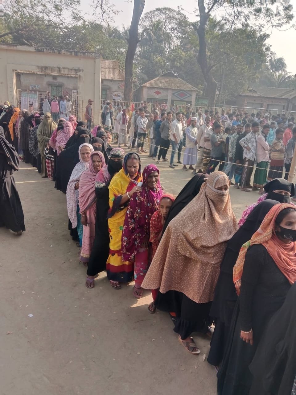 Women standing in a line at a community event